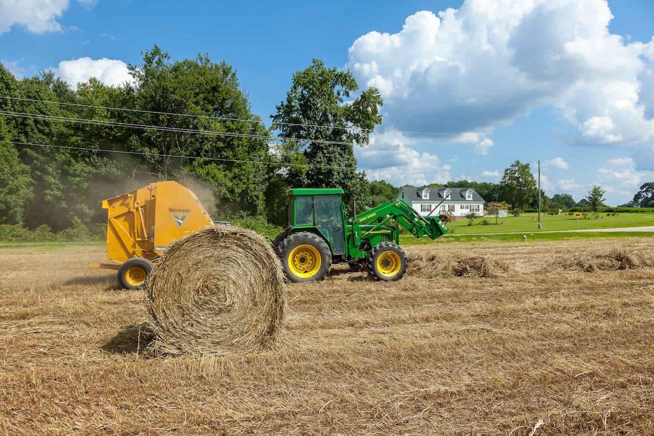 Tractor baling hay in a field